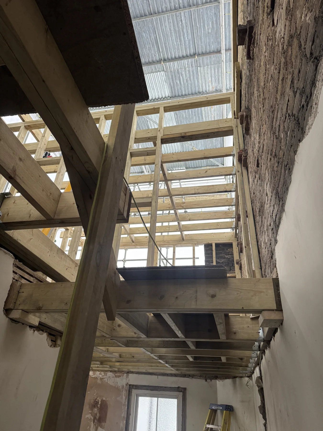 Exposed timber floor and roof structure during a Bluebird Spaces loft conversion in South West London