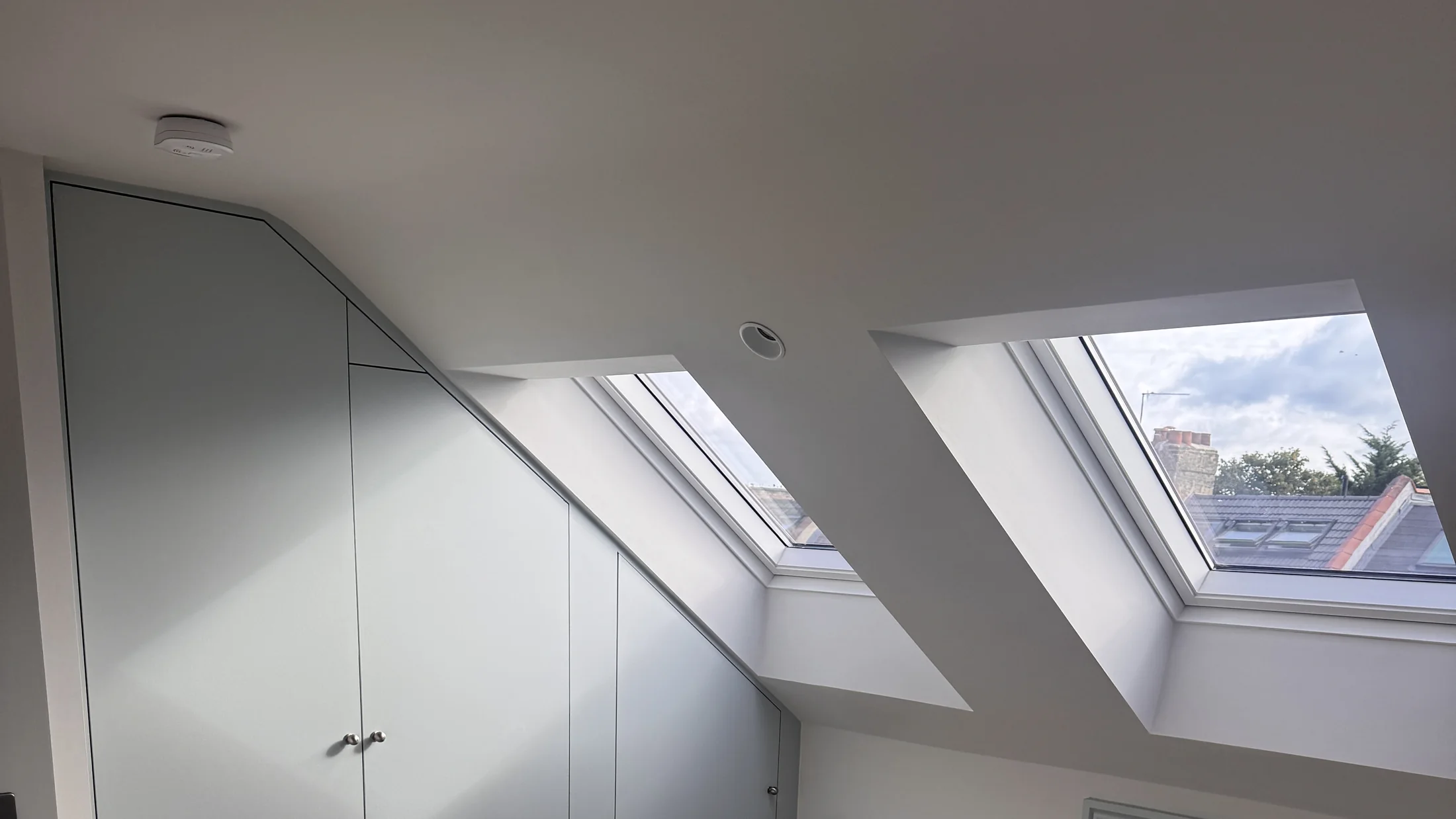 Completed loft conversion with fitted eaves storage and rooflights by Bluebird Spaces