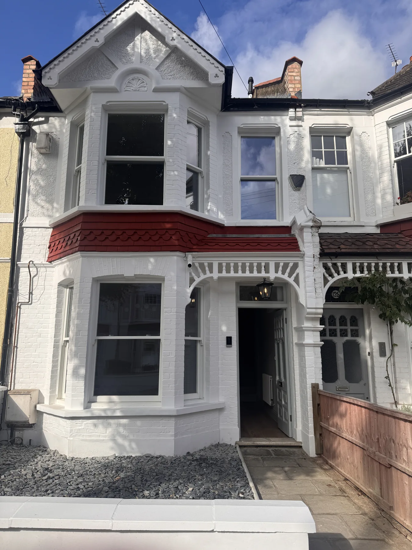 Restored front elevation with replacement windows at the completed Wimbledon renovation